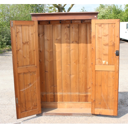 75 - A vintage stained pine hall cupboard with doors, likely early 20th century, approx 122cm wide x 192c... 