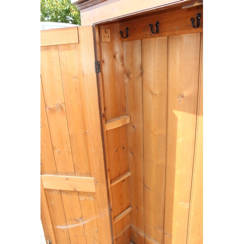 75 - A vintage stained pine hall cupboard with doors, likely early 20th century, approx 122cm wide x 192c... 