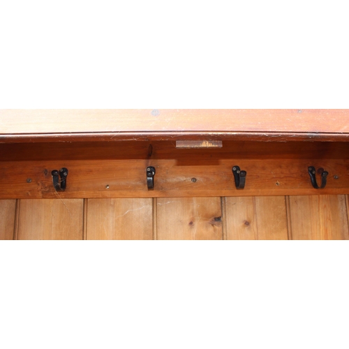 75 - A vintage stained pine hall cupboard with doors, likely early 20th century, approx 122cm wide x 192c... 