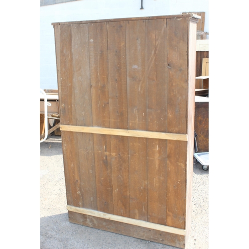 75 - A vintage stained pine hall cupboard with doors, likely early 20th century, approx 122cm wide x 192c... 