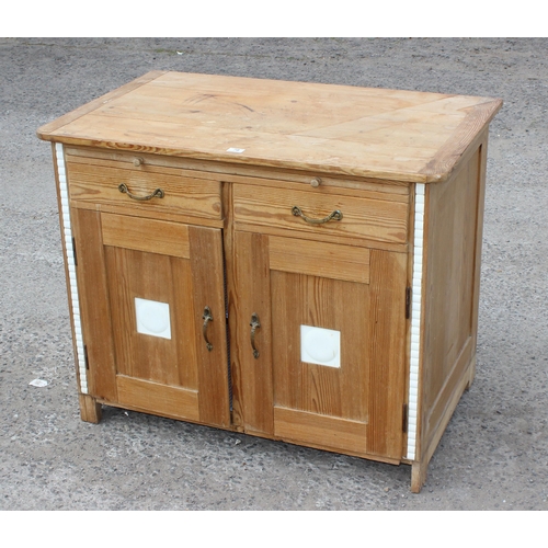 78 - An antique pine sideboard or cabinet with 2 doors under 2 drawers and a single slide, set with moder... 