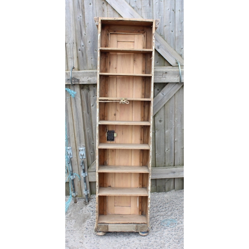 100 - An unusual tall slim Victorian pine doored cabinet with 7 interior shelves, no back, approx 148cm ta... 