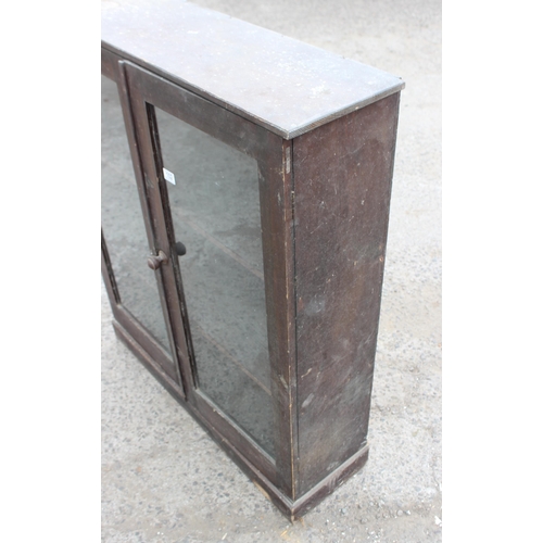 102 - An antique stained pine glazed bookcase, approx 95cm wide