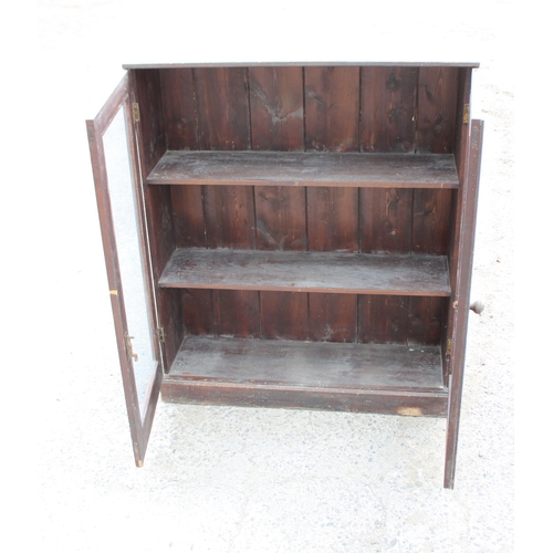 102 - An antique stained pine glazed bookcase, approx 95cm wide