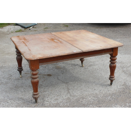 105 - A large antique dining table with pine top and mahogany base, approx 150cm x 130cm