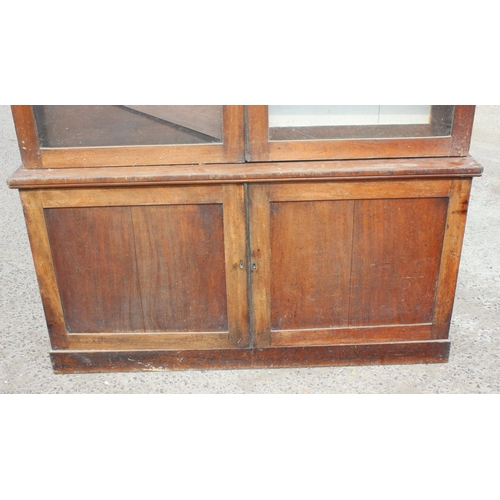 109 - A large 19th century mahogany glazed bookcase with cupboard base, approx 220cm tall x 158cm wide