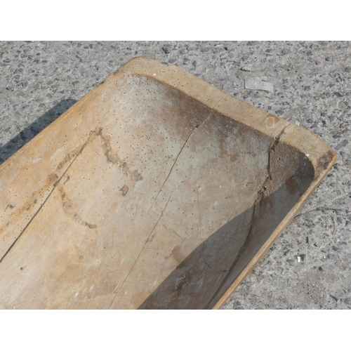 112 - A European wooden trencher style dough bowl or trough with vintage metal repair, approx 82cm x 40cm