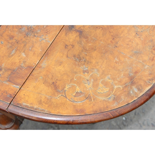 125 - An antique mahogany Pembroke table with Sheraton inlay and an antique walnut inlaid Sutherland table... 