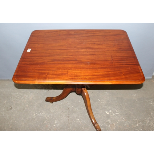 129 - An antique mahogany tilt top table with turned tripod pillar support, approx 89cm x 68cm