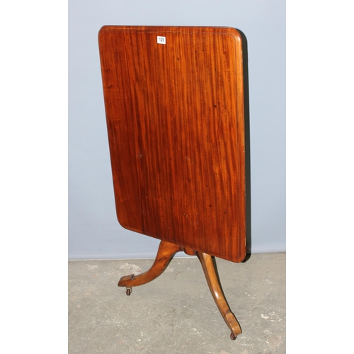 129 - An antique mahogany tilt top table with turned tripod pillar support, approx 89cm x 68cm