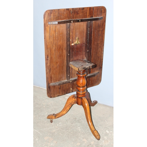 129 - An antique mahogany tilt top table with turned tripod pillar support, approx 89cm x 68cm