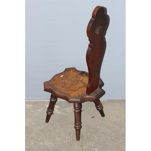 141 - An early 20th century Scottish pokerwork spinning chair decorated with thistles, approx 97cm tall