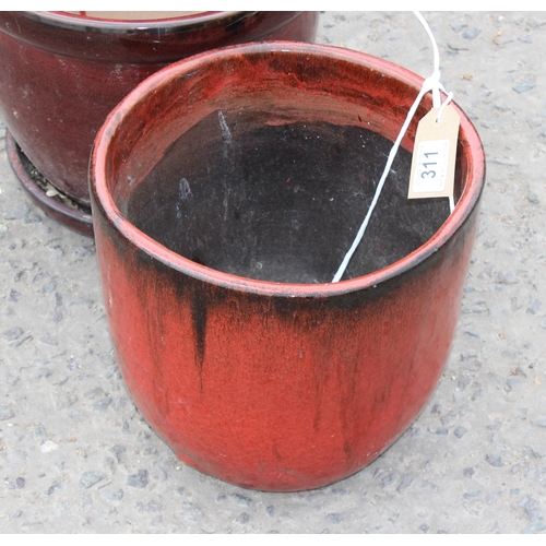 311 - 2 red glazed garden pots, the largest approx 32cm in diameter