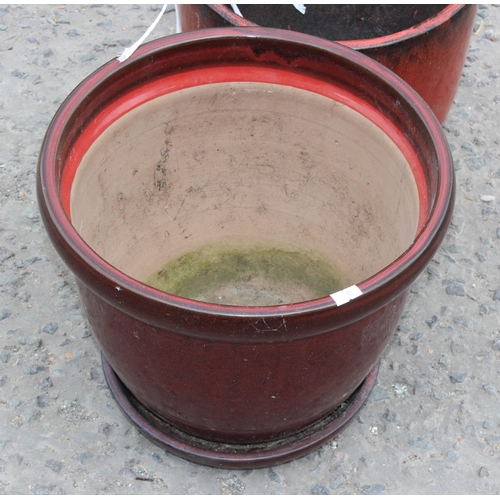 311 - 2 red glazed garden pots, the largest approx 32cm in diameter