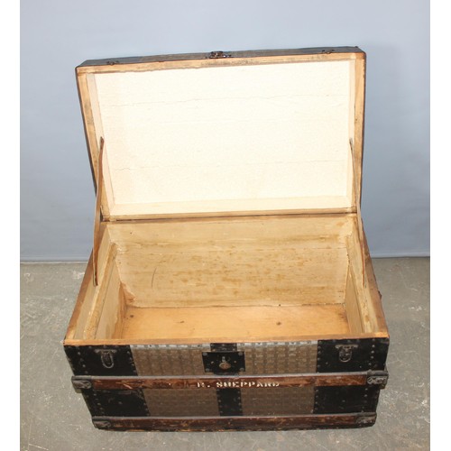 27 - A large vintage metal banded shipping trunk with flat top, approx 77cm wide x 47cm deep x 56cm tall