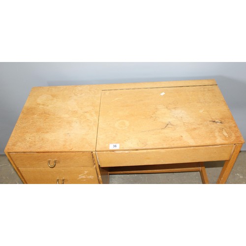 37 - A retro Stag 3 drawer desk with lift up lidded compartment, approx 97cm wide