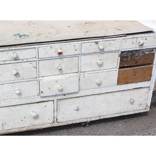 71 - A Victorian painted pine haberdashery shop counter consisting of 27 different sized drawers to one s... 