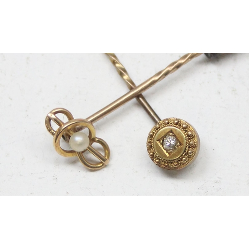 1146A - 2 antique 15ct gold stick pins, one set with seed pearl the other a small diamond, the heads both 15... 