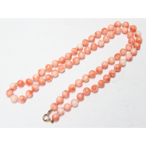 1136 - A pink coral bead necklace with 9ct gold clasp and a pair of associated 9ct gold and coral earrings