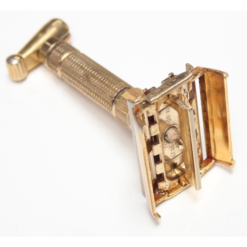 1608 - An unusual vintage Gillette gold plated razor, believed to be a D-1 Toggle