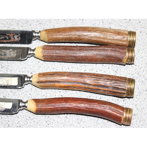 1026 - Part set of four Hoffritz etched hunting scene steel bladed steak knives with antler bone handles in... 