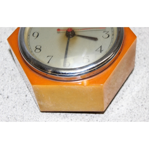 1309 - Art Deco Goblin electric clock in hexagonal butterscotch colour Bakelite case, approx 12cm wide x 12... 