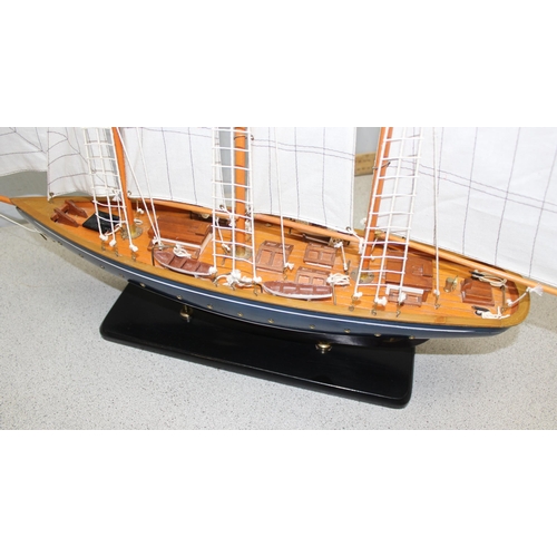 1523 - Large multi-sailed painted wooden hulled model yacht on ebonised stand - approx 60cm long by 70cm ta... 