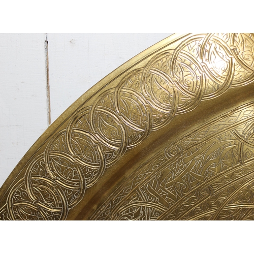 1748 - Large Middle Eastern brass charger, approx 69cm diameter