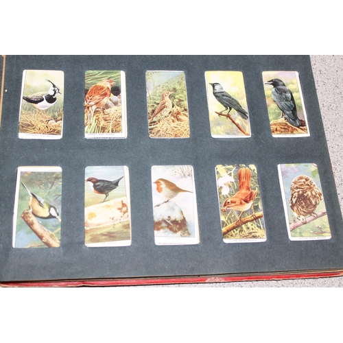 511 - Early 20c Wills cigarette card album containing four near but incomplete sets of Dandies, butterflie... 