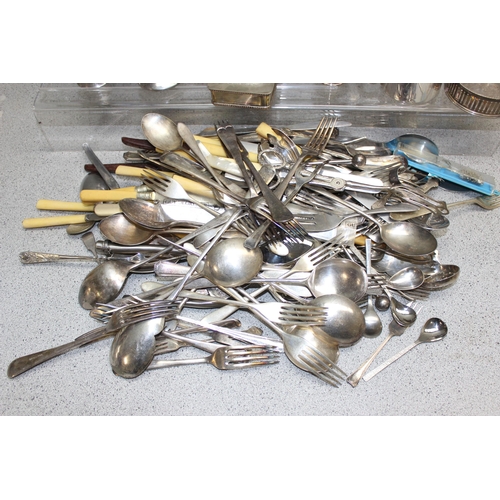 1039A - A large qty of assorted antique and later silver plated items to inc cutlery and a chamber stick, ap... 