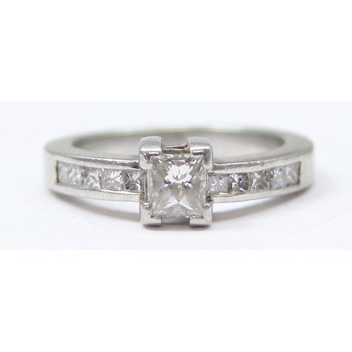 1151A - A Platinum ring set with a large central square Princess cut diamond and flanked with 5 similar squa... 