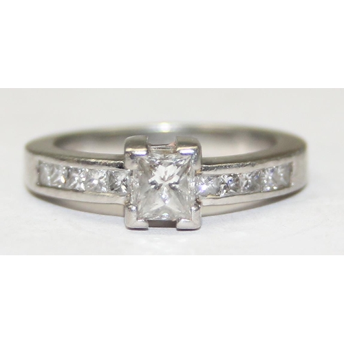 1151A - A Platinum ring set with a large central square Princess cut diamond and flanked with 5 similar squa... 