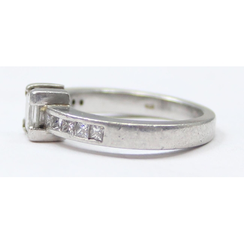 1151A - A Platinum ring set with a large central square Princess cut diamond and flanked with 5 similar squa... 