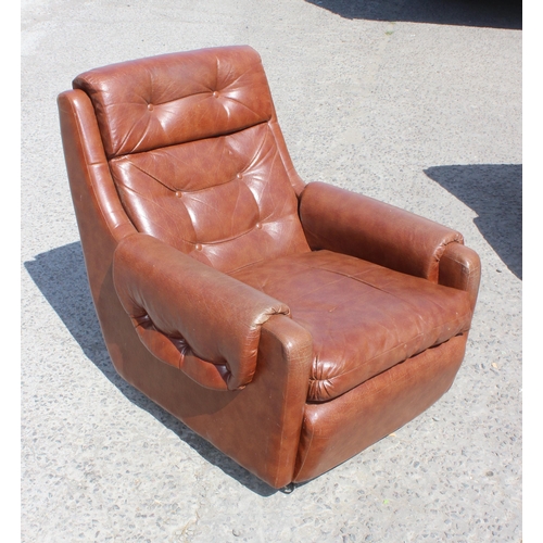 173 - A pair of retro 1970's brown faux leather armchairs