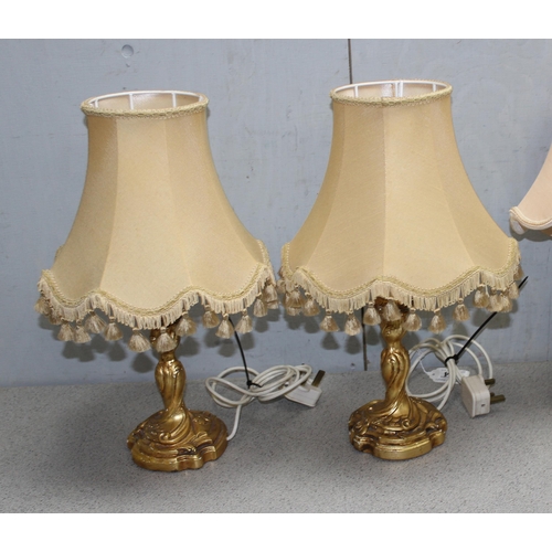 264 - A trio of Florentine style gilt gesso table lamps, 2 with matching shades