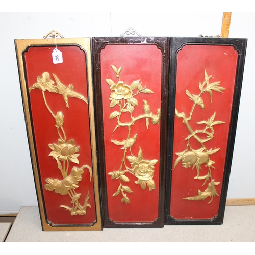 285 - A set of 3 20th century carved wooden panels depicting flora and birds, each approx 91cm x 30cm