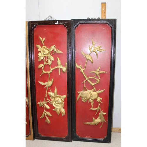 285 - A set of 3 20th century carved wooden panels depicting flora and birds, each approx 91cm x 30cm