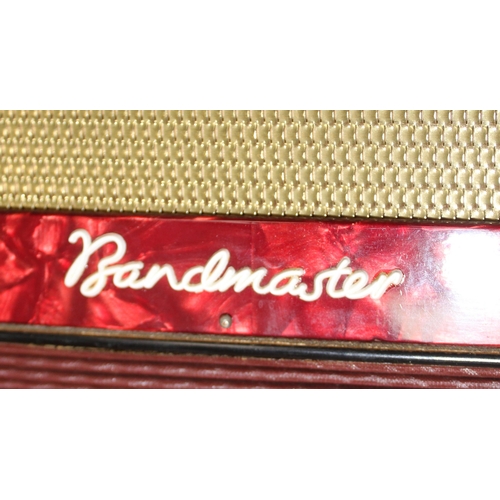 607 - Cased Bandmaster accordion with red marbled finished