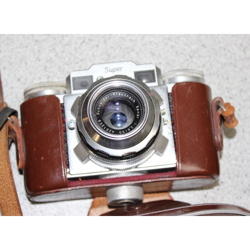 690 - 2 Super Paxette cameras in leather cases with a large number of accessories