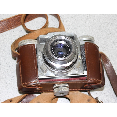 690 - 2 Super Paxette cameras in leather cases with a large number of accessories