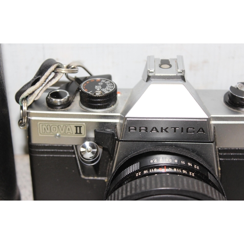 692 - Praktica Nova II 35mm camera with various accessories and lenses to inc Carl Zeiss