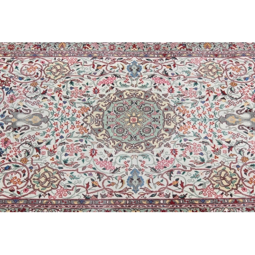 209 - A decorative and finely woven cream ground rug, likely Persian, approx 220cm x 125cm