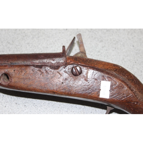 1409 - An antique North African Camel gun, 1817 dated flintlock lock plate and distinctive curved wooden hi... 