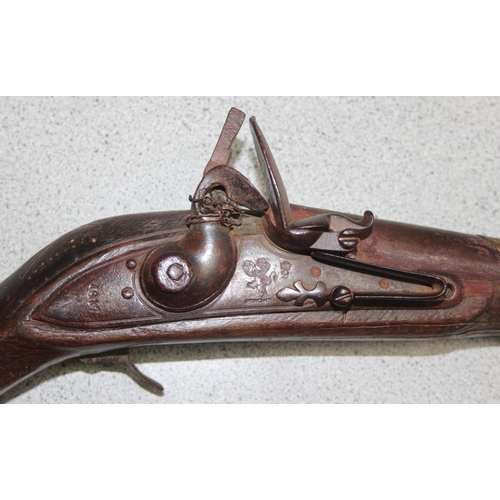 1409 - An antique North African Camel gun, 1817 dated flintlock lock plate and distinctive curved wooden hi... 