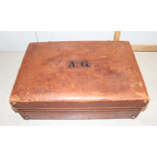 281 - 2 vintage leather suitcases, larger one monogrammed 'AG' with silk interior