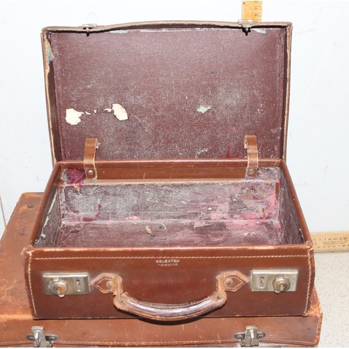 281 - 2 vintage leather suitcases, larger one monogrammed 'AG' with silk interior