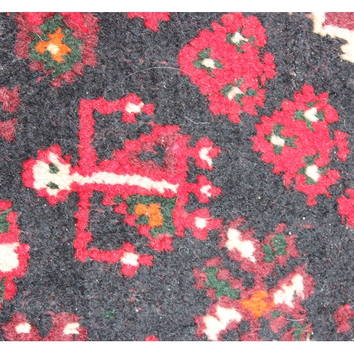 204 - A large vintage Abadeh rug of red ground, approx 294cm x 213cm