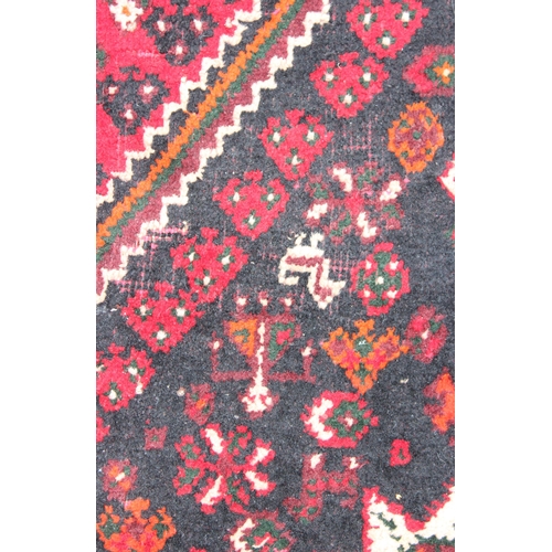 204 - A large vintage Abadeh rug of red ground, approx 294cm x 213cm