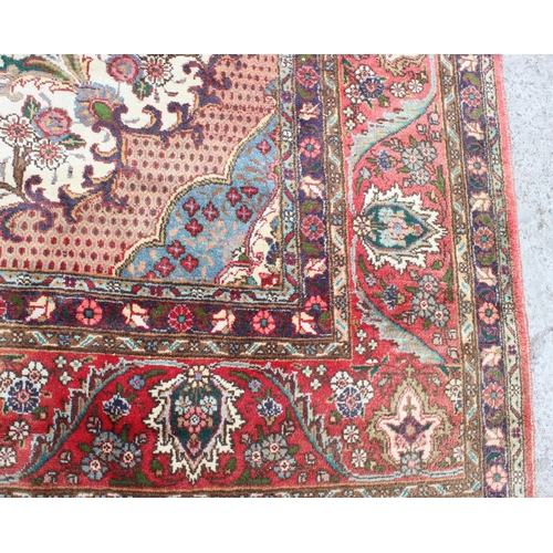 205 - A large decorative red ground rug with arabesque border, approx 400cm x 290cm