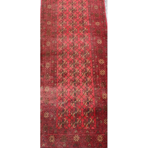 207 - A large vintage red ground runner rug, approx 295cm x 83cm